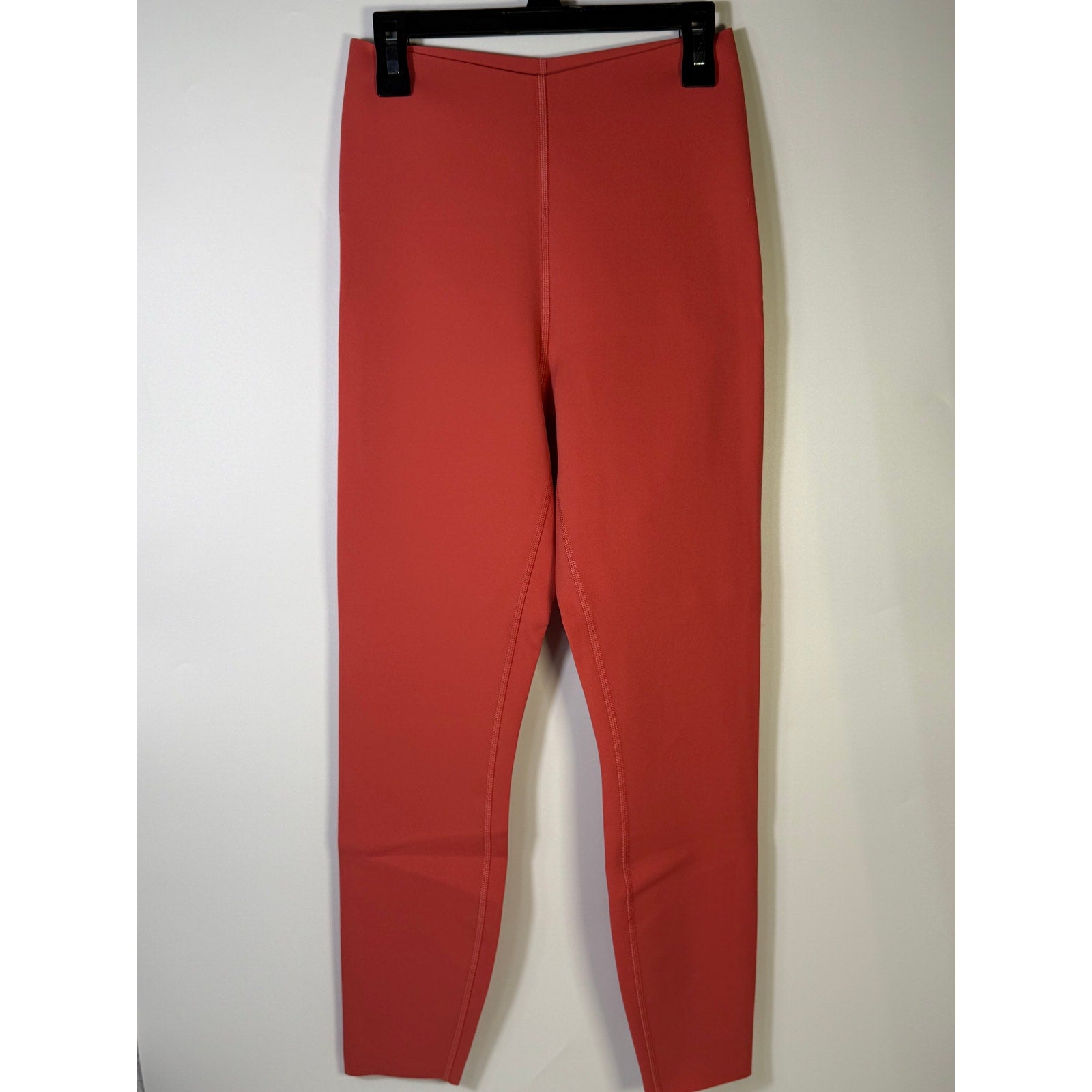 Lululemon Glow Up HR Tight 25-inch women's red leggings shown on a model, featuring a high-rise fit and athletic design.