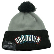 New Era Brooklyn Nets knit beanie hat with embroidered logo and removable pom, cozy winter accessory.