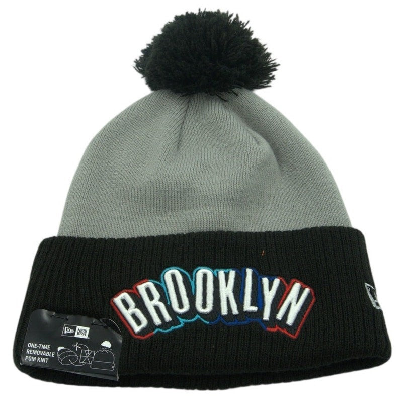 New Era Brooklyn Nets knit beanie hat with embroidered logo and removable pom, cozy winter accessory.