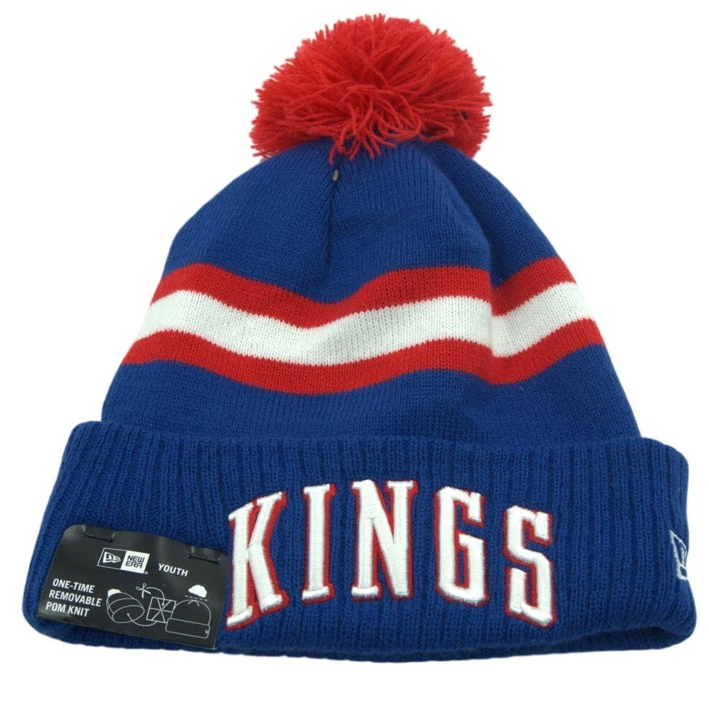 Youth blue and red New Era NBA Sacramento Kings pom beanie hat with team logo, knit design, warm and stylish for fans.