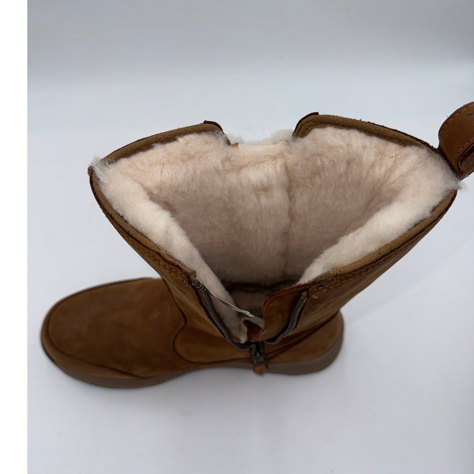 UGG waterproof leather winter boots in chestnut for women, size 9.5W, featuring a cozy fur lining and sturdy sole.