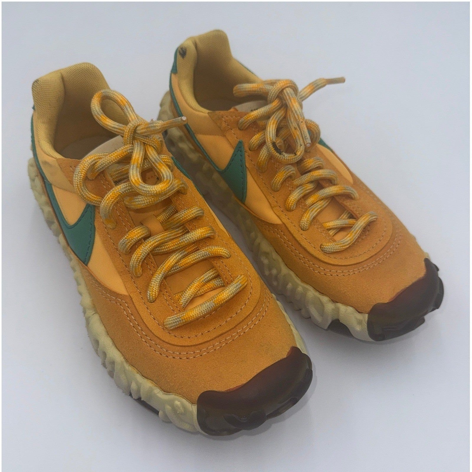 Nike OverBreak SP Pollen Rise Neptune Green women's sneakers with white and green accents, showing side view and stylish design.
