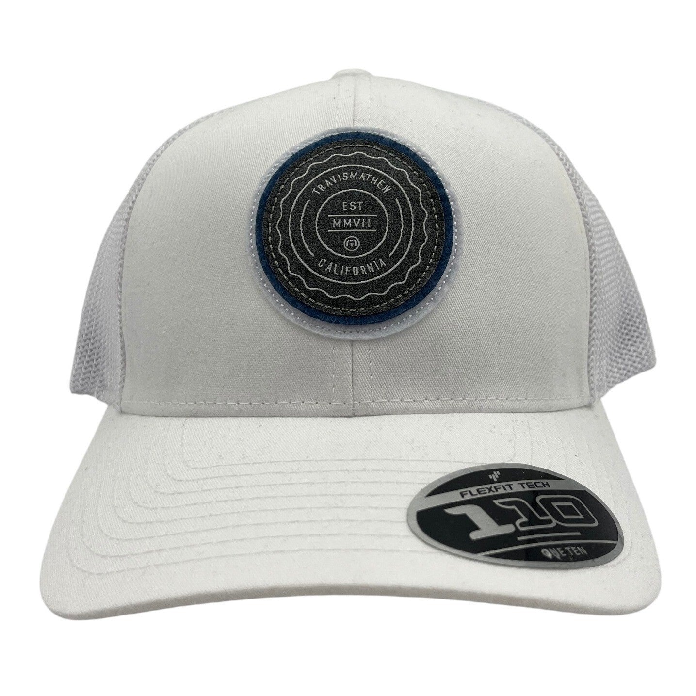 TravisMathew FlexFit Tech hat with "The Patch" style, featuring a structured design and adjustable fit in neutral color.