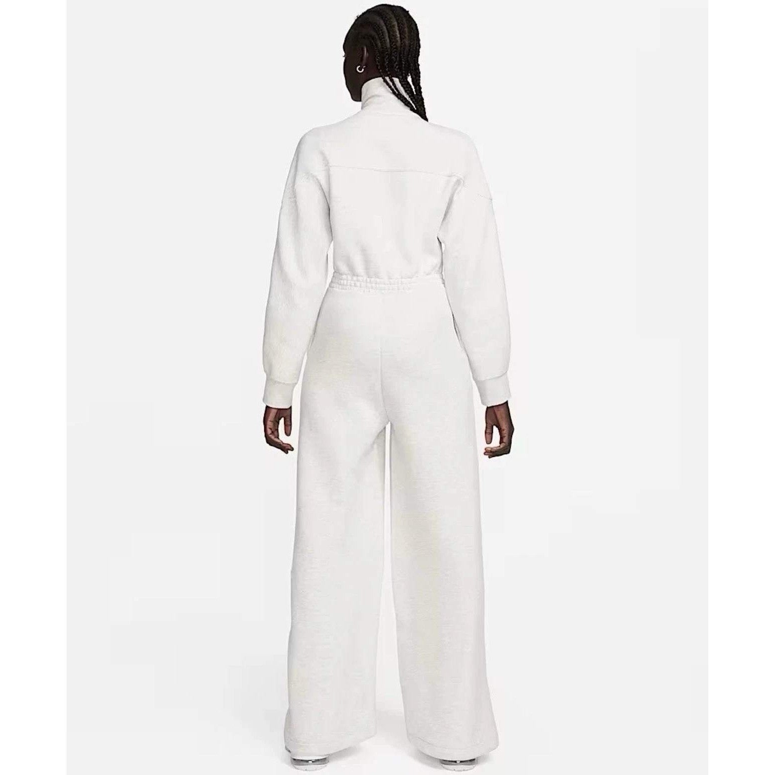 Nike Tech Fleece Windrunner jumpsuit in grey, front view showing the sleek, fitted design with Nike branding on the chest.