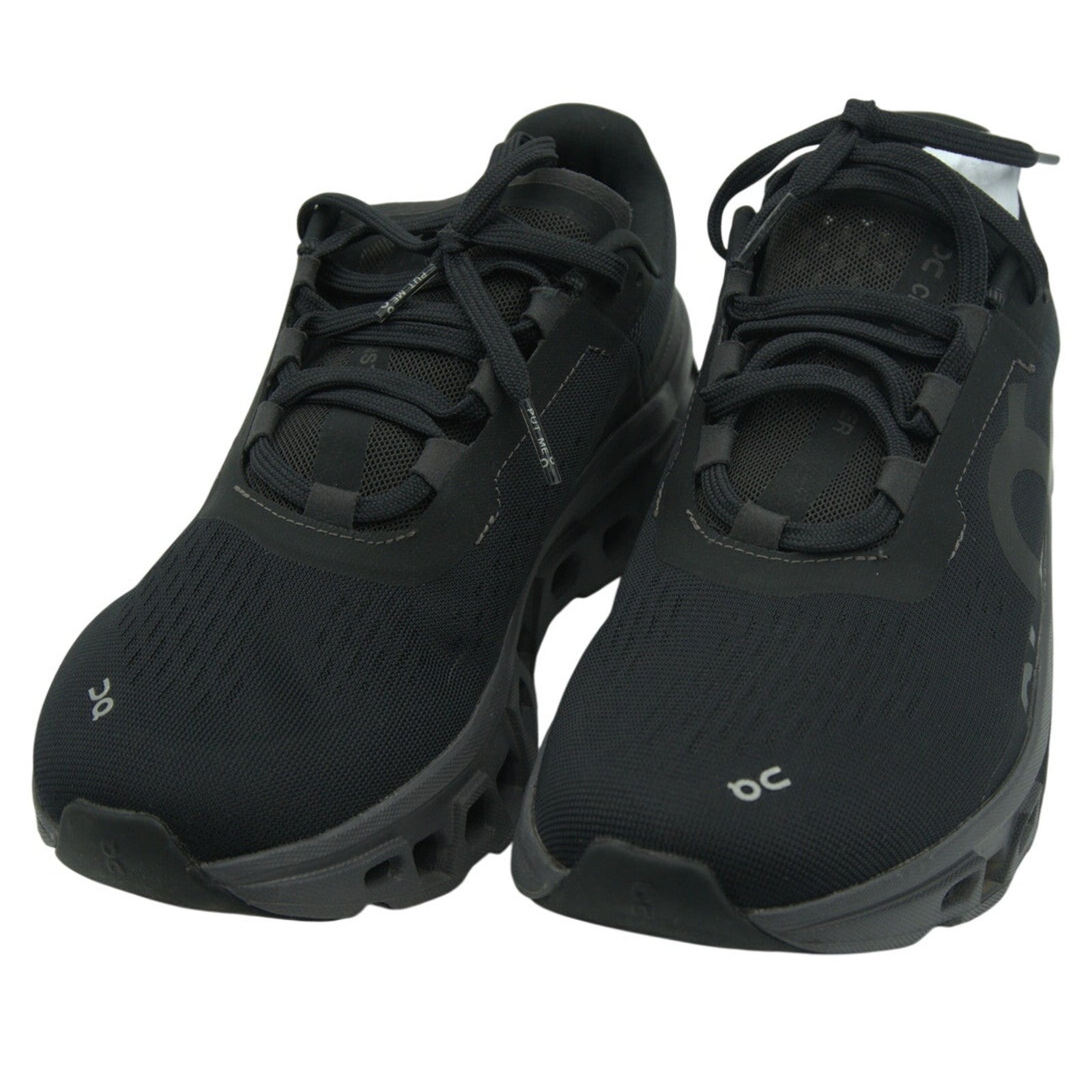 On Running Cloudmonster women's sneakers in black and magnet color, showing the stylish athletic design and cushioning details.