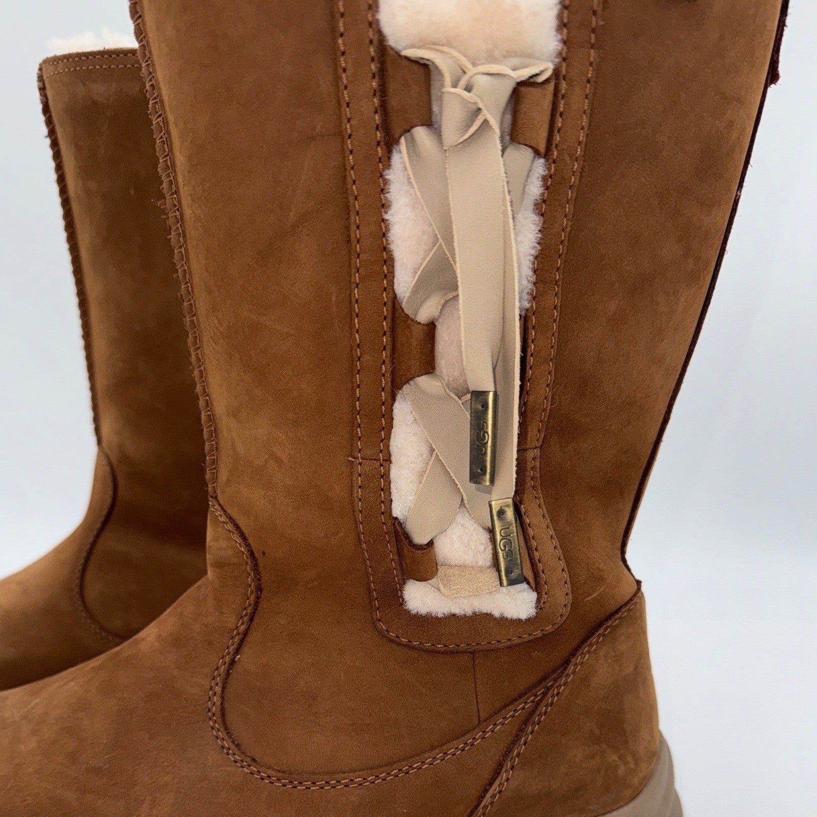 Women's UGG waterproof leather winter boots in chestnut, size 9.5W, featuring a stylish design and sturdy sole.