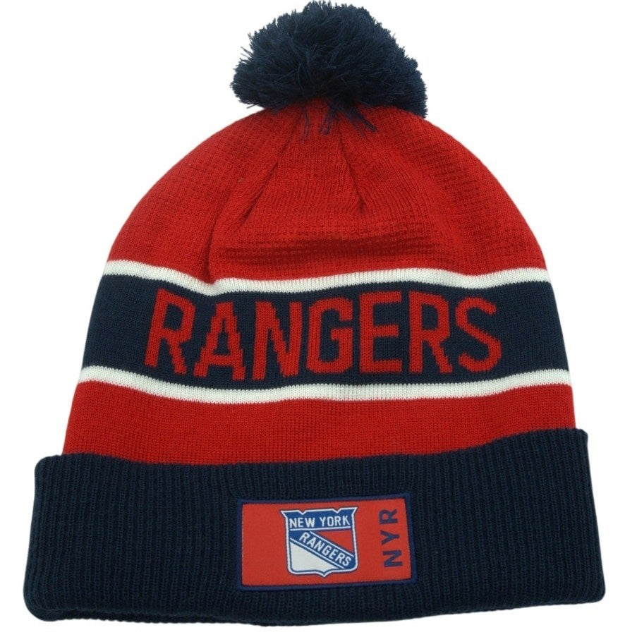 Fanatics New York Rangers pom beanie with embroidered NHL logo, knit hat featuring team colors and pom on top.