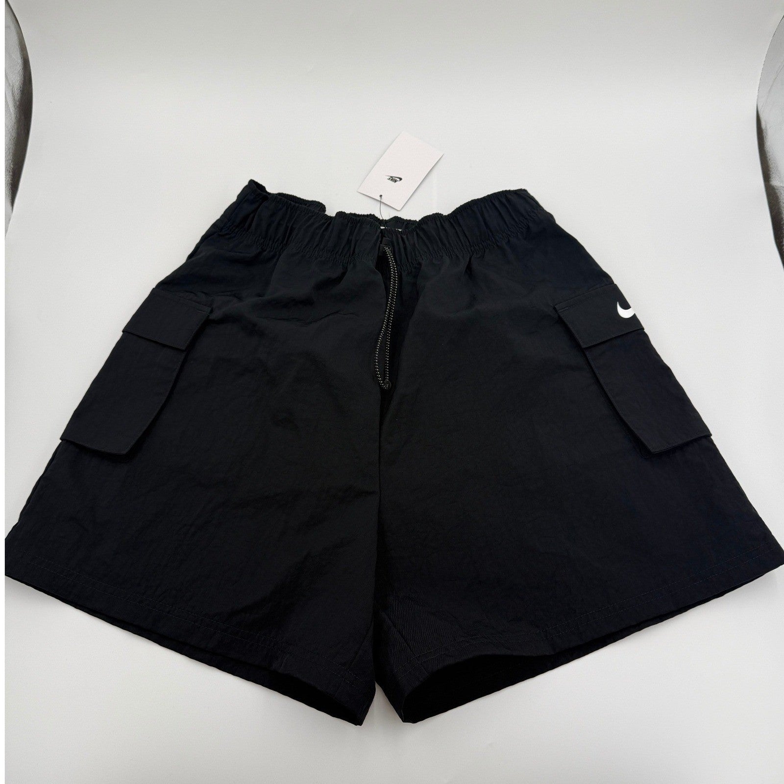 Nike Sportswear Essential women's woven high-rise shorts in medium, featuring a comfortable fit and stylish design.