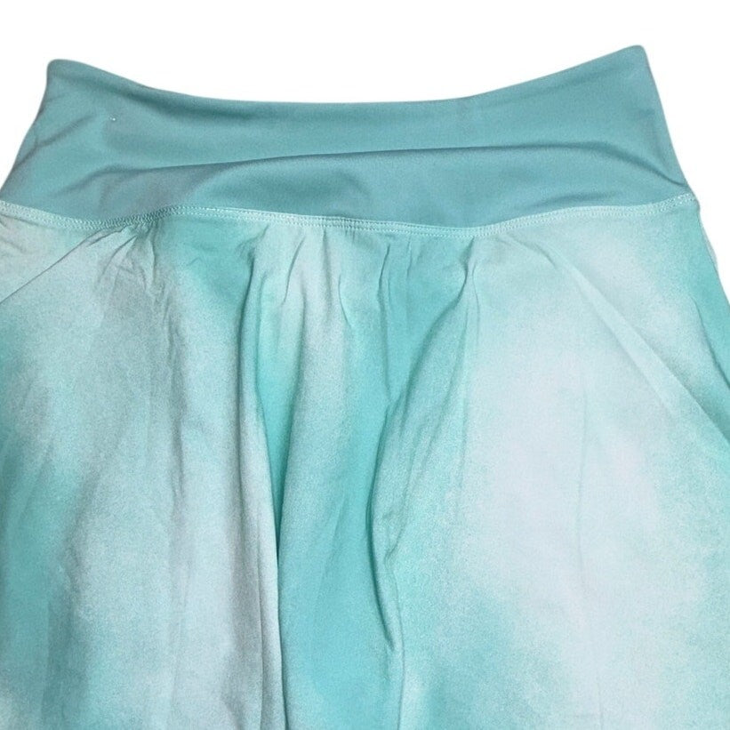 Nike Dri-FIT women's tennis skirt in small, showing the navy blue fabric with subtle Nike logo detail and pleated design.