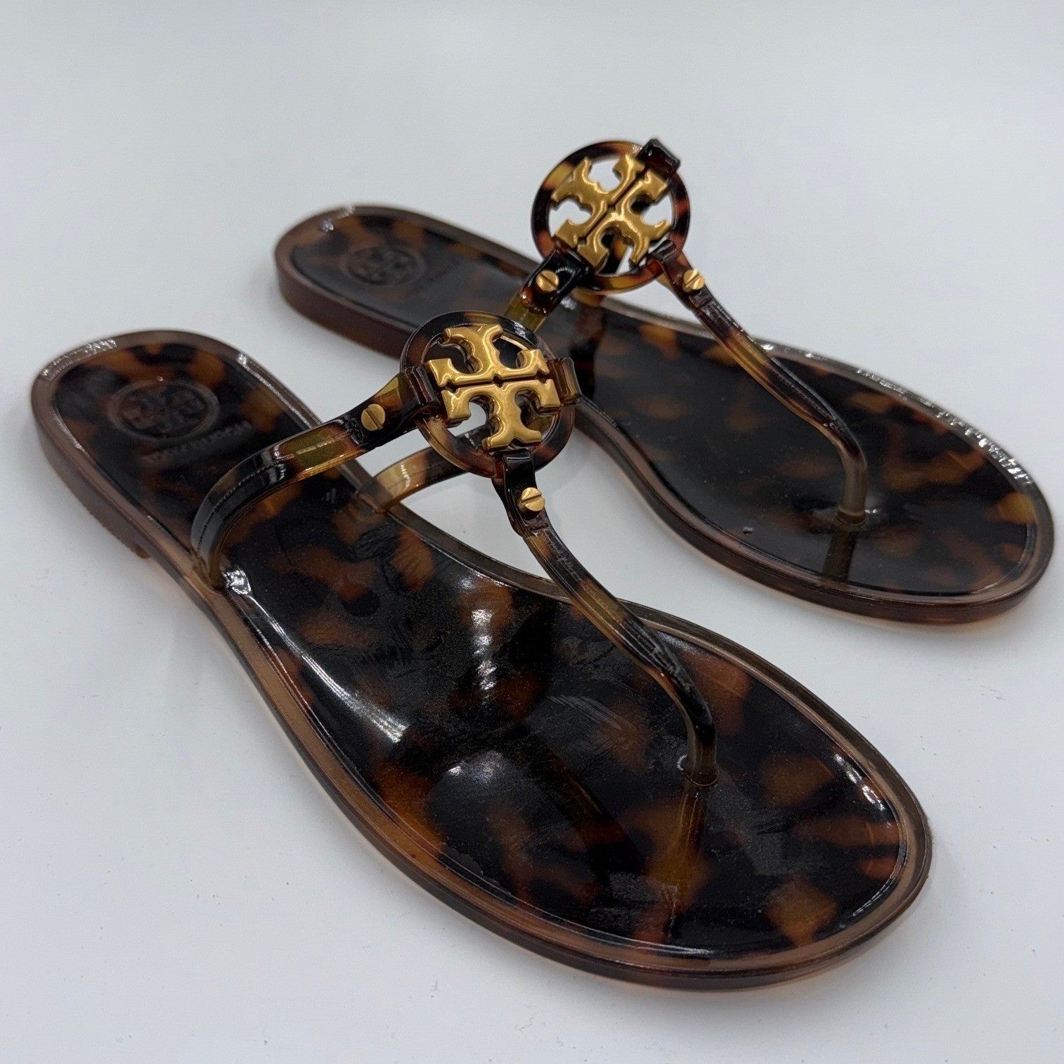 Tory Burch Mini Miller sandals in tortoise shell jelly, women's size 8, featuring a sleek strap design and glossy finish.