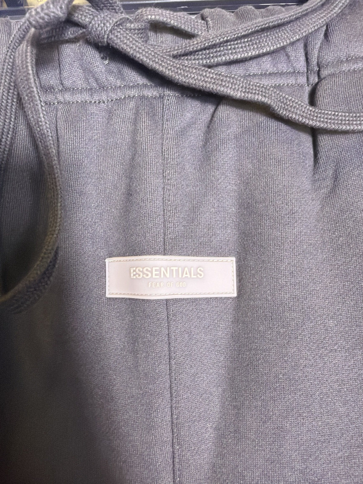 Fear of God Essentials 1977 sweatpants in iron color, size XXL, showing relaxed fit and soft fabric details.