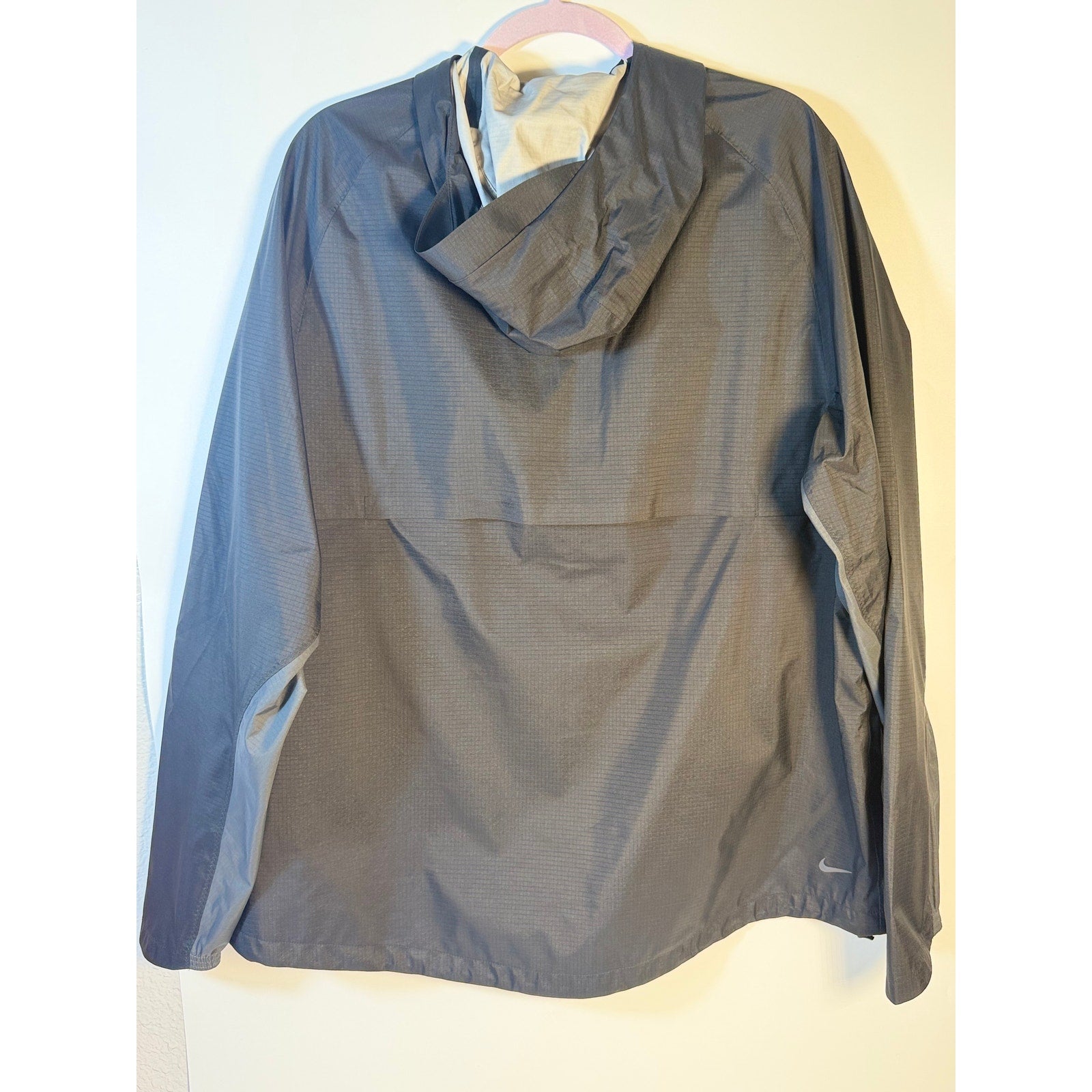 Nike men's gray Windrunner hooded jacket with full zipper, size XL, displayed on a hanger.