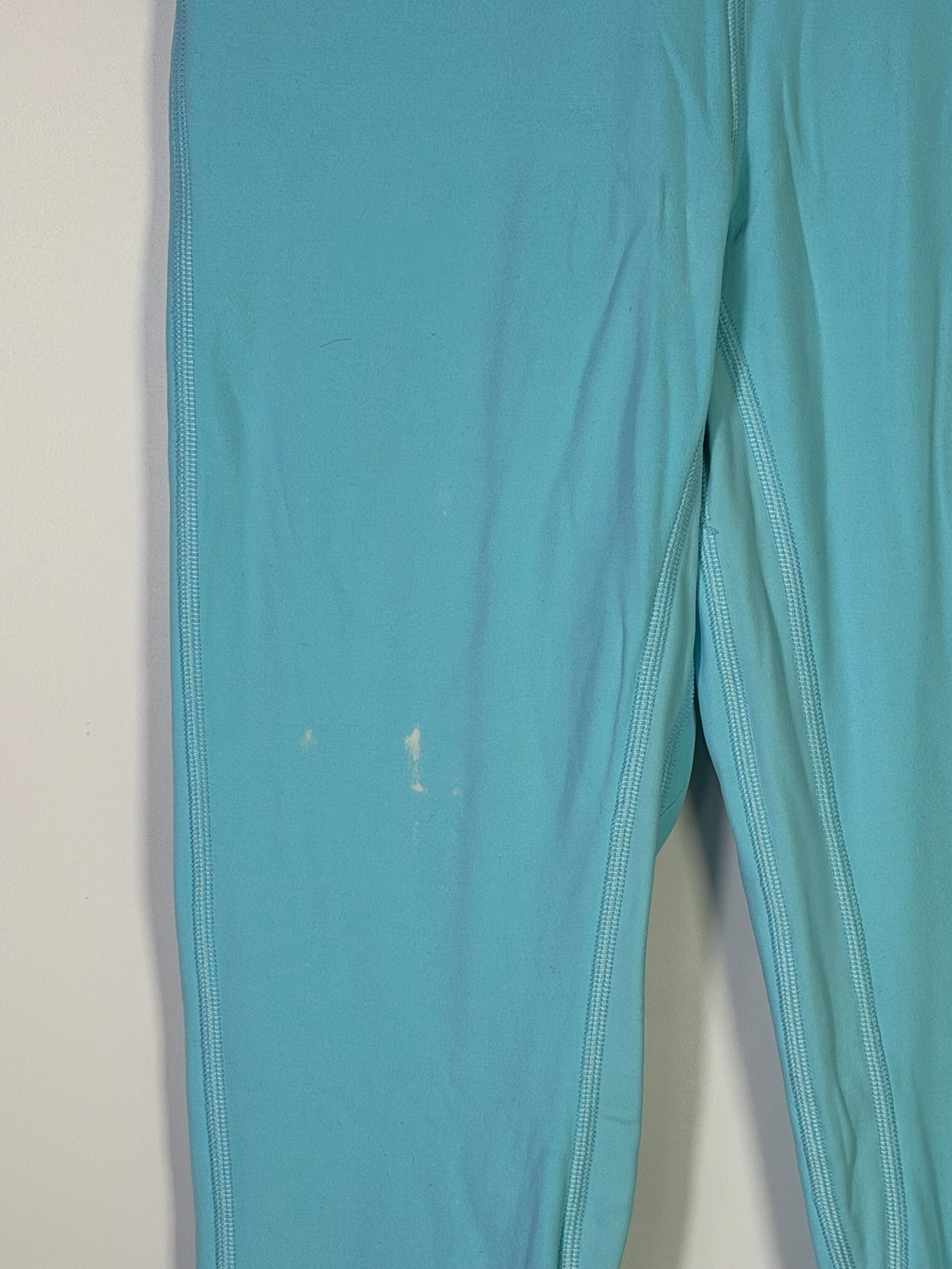 Lululemon women's size 4 aqua blue high-rise full-length leggings displayed on a model, highlighting the fitted athletic clothing.