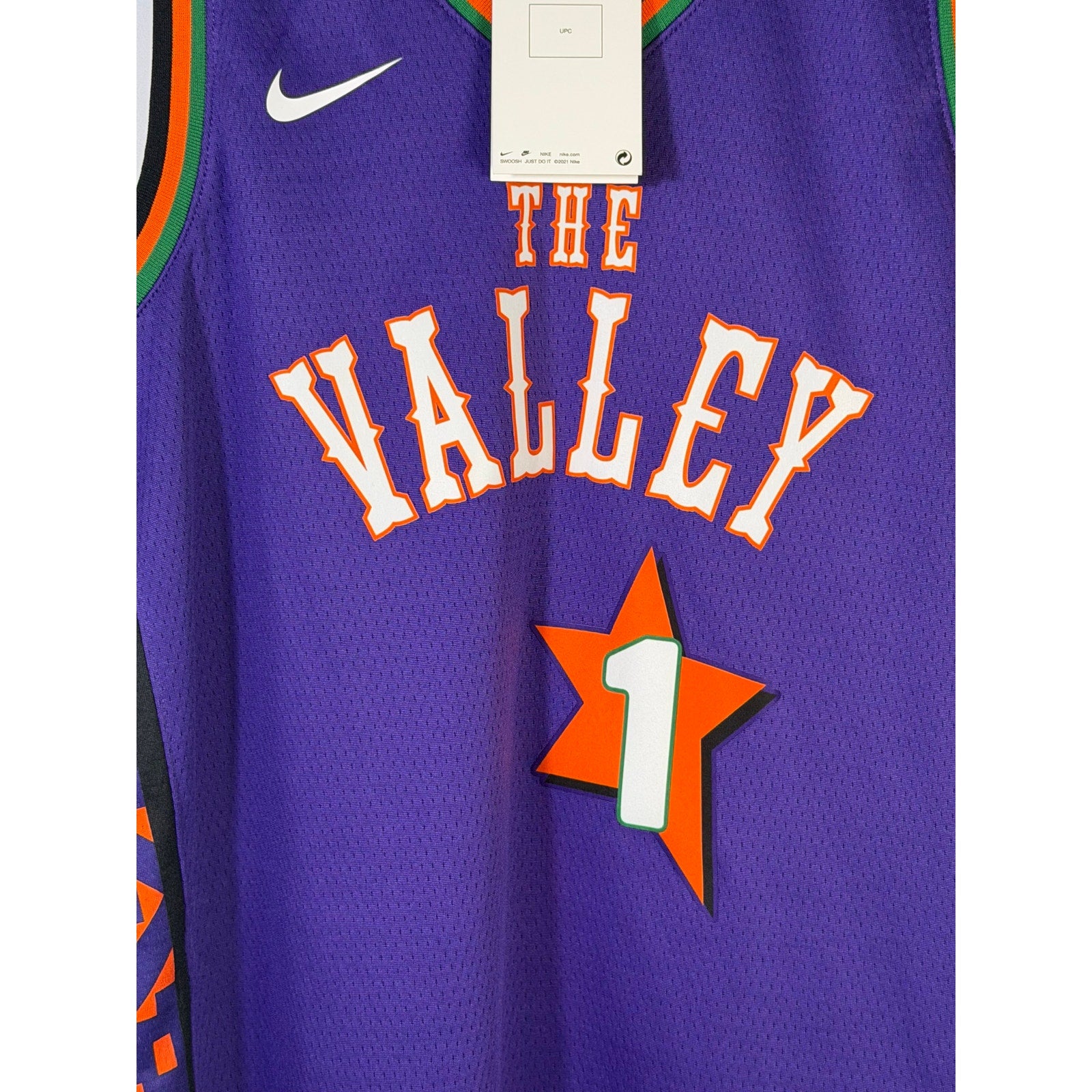 Nike Phoenix Suns Devin Booker #1 youth purple jersey, size L 14/16, featuring team logo and player number in vibrant purple.