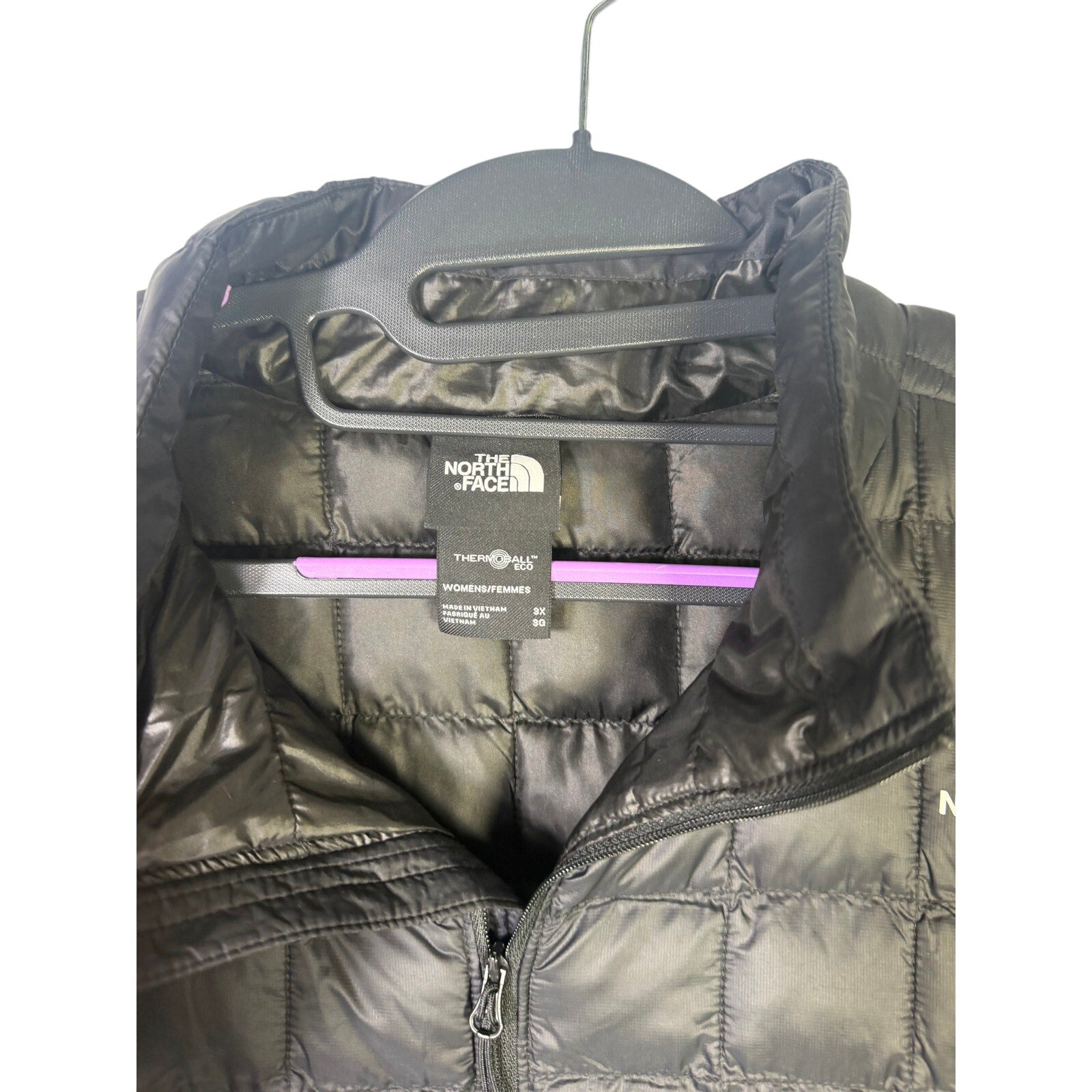 The North Face Women’s Plus ThermoBall Eco Jacket in black, size 3X tall, displayed hanging with front view and zip closure.