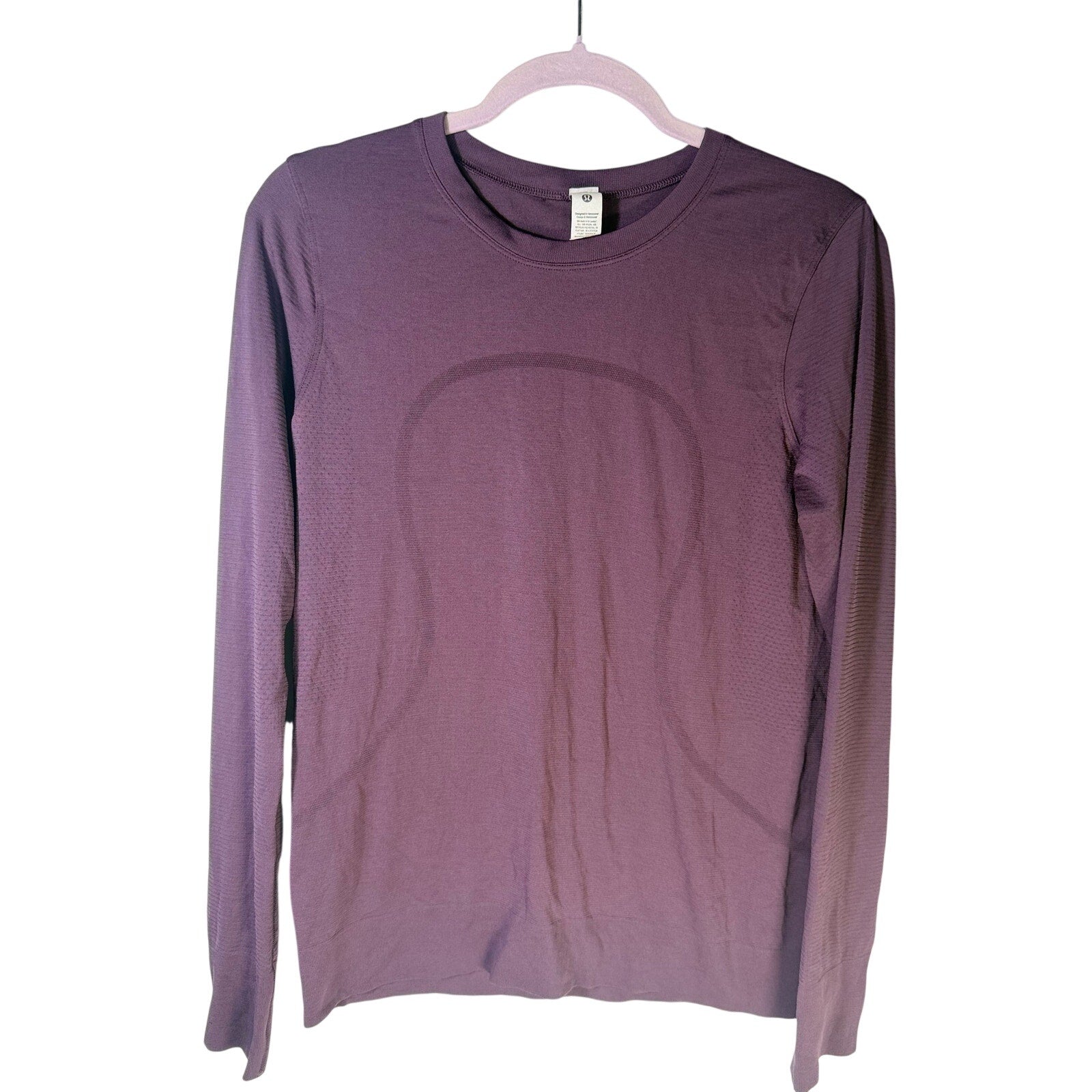 Lululemon women’s Swiftly Tech long-sleeve athletic shirt in purple, size 6, featuring lightweight, breathable fabric for workouts.