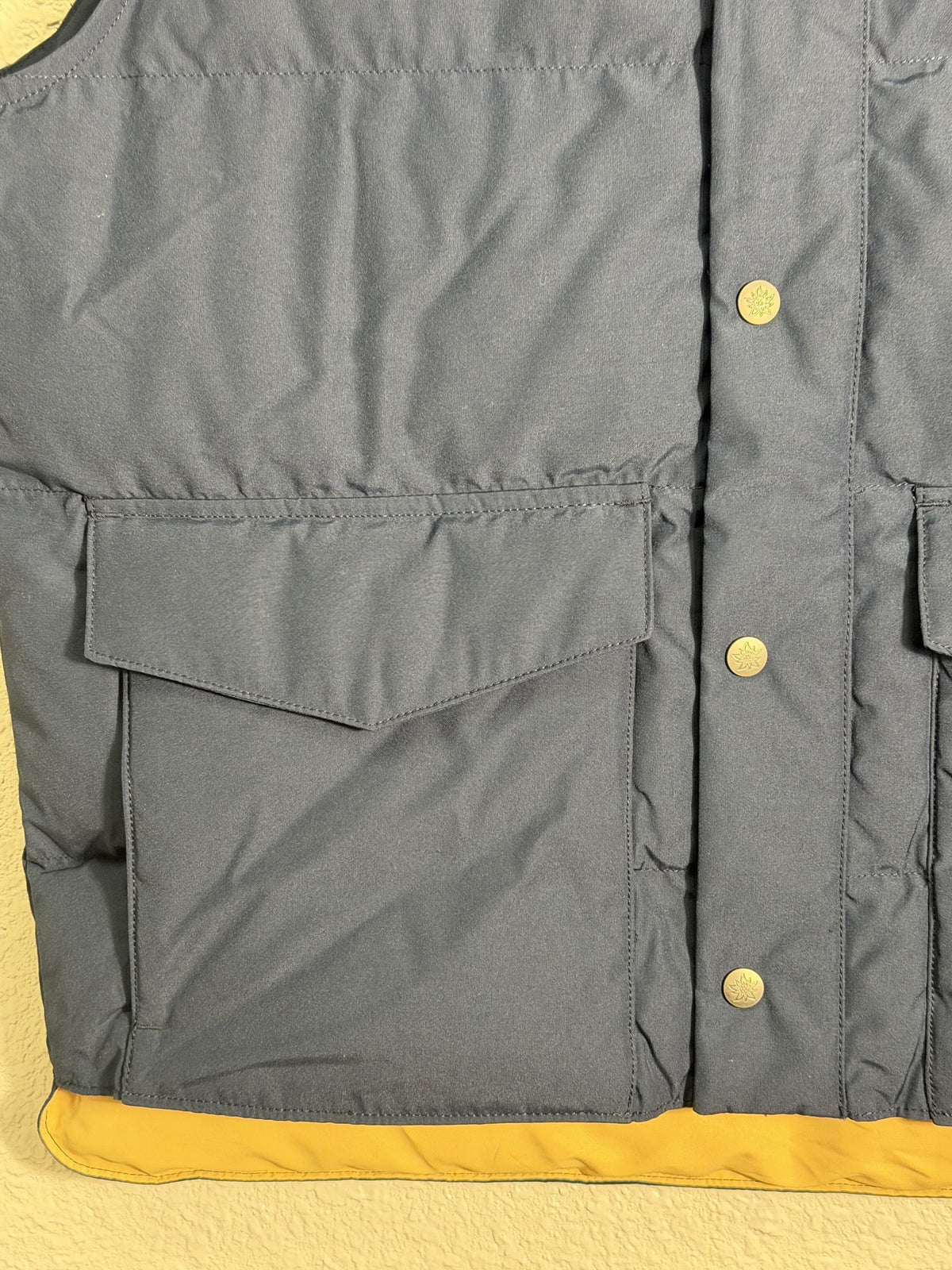 Men's Alpine Design AD 1962 Puffer Vest in vintage blue, medium size, featuring quilted insulation and stand-up collar.