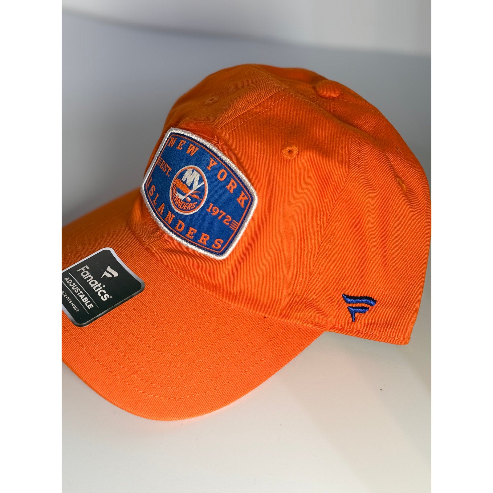 Fanatics New York Islanders adjustable orange dad hat with embroidered team logo and curved brim, one size fits most.