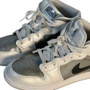 White, gray, and black Air Jordan 1 Mid GS sneakers for youth, size 7Y, showing the classic design and Jordan branding.