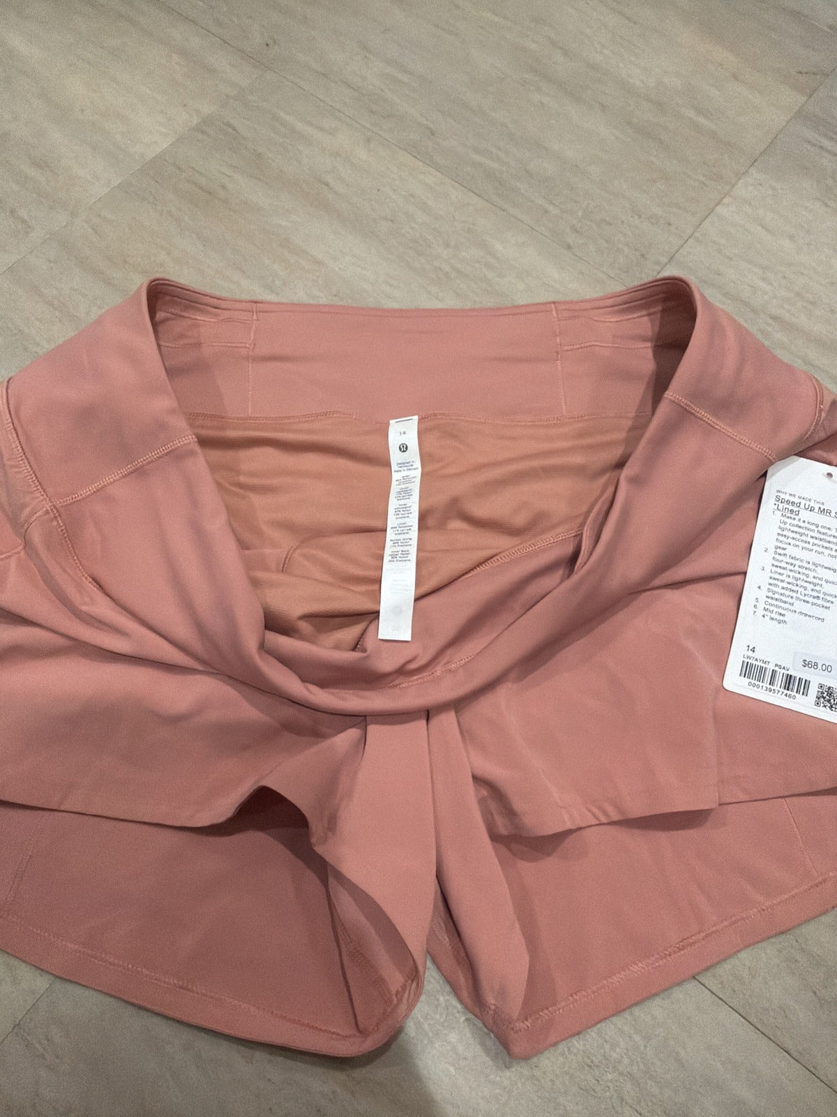 Lululemon Speed Up mid-rise lined shorts in Pink Savannah, women's size 14, showing the lightweight, fitted athletic shorts design.
