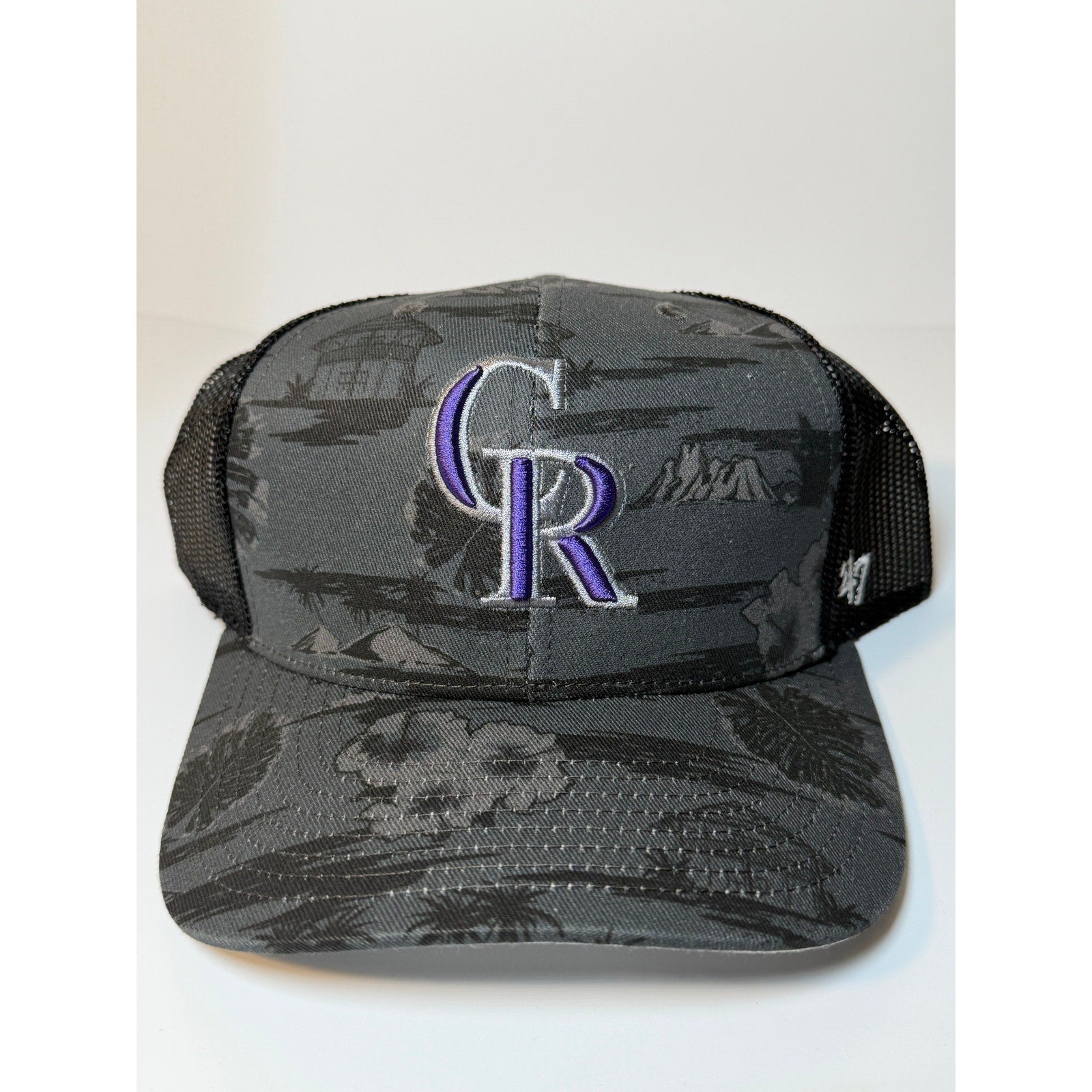 Gray and black 47 Brand Colorado Rockies trucker hat with floral snapback, adjustable fit and breathable mesh back.