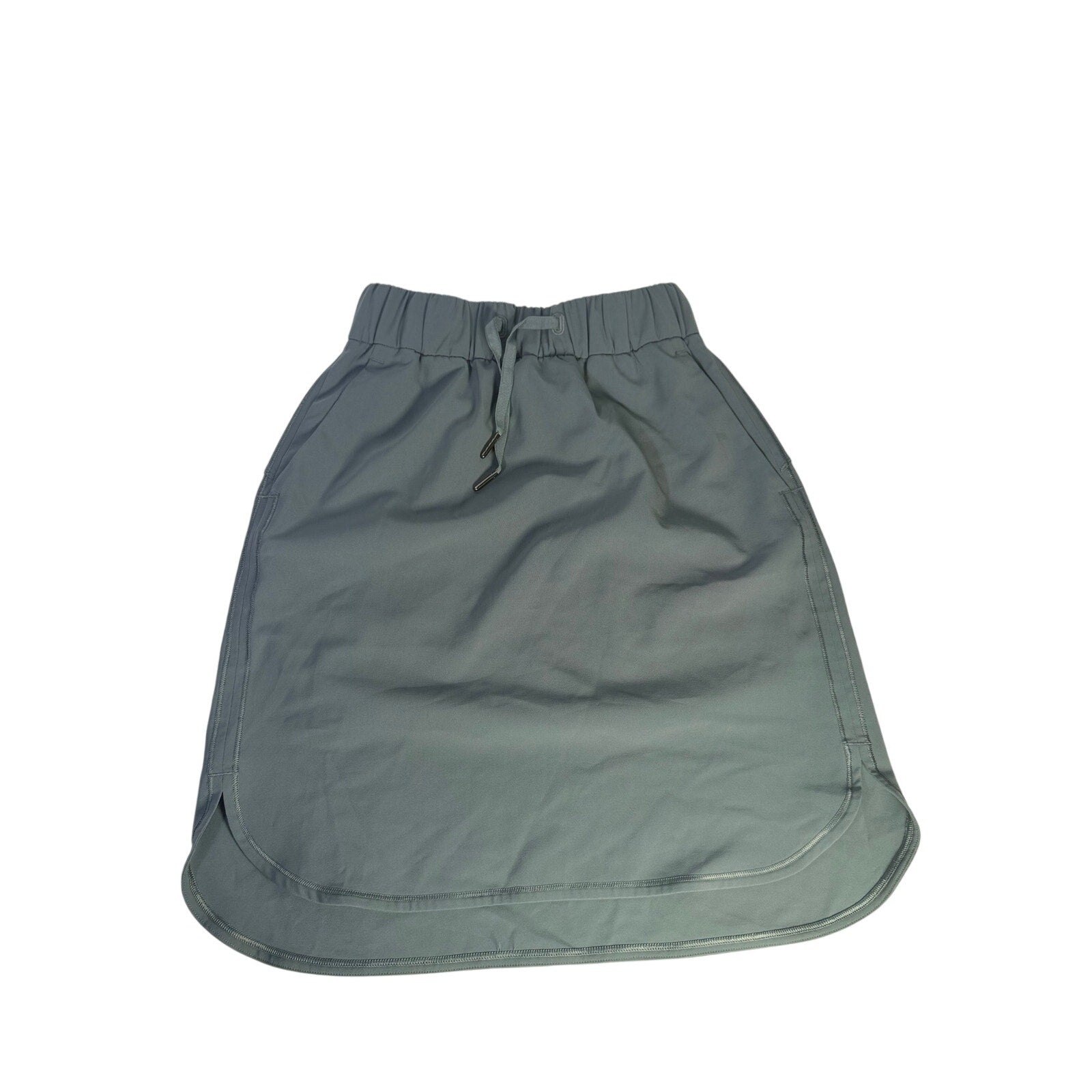 Lululemon women’s sage gray pull-on athletic skirt, size 2, shown flat with waistband and lightweight fabric detail