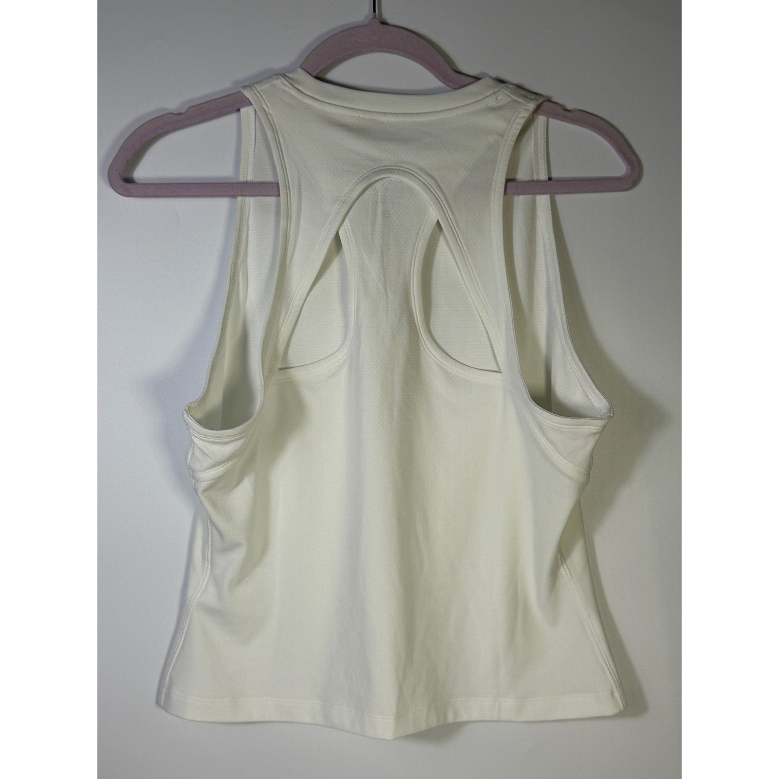 NikeCourt women's Dri-FIT tennis tank top in white, size large, shown with sleeveless design and athletic fit.