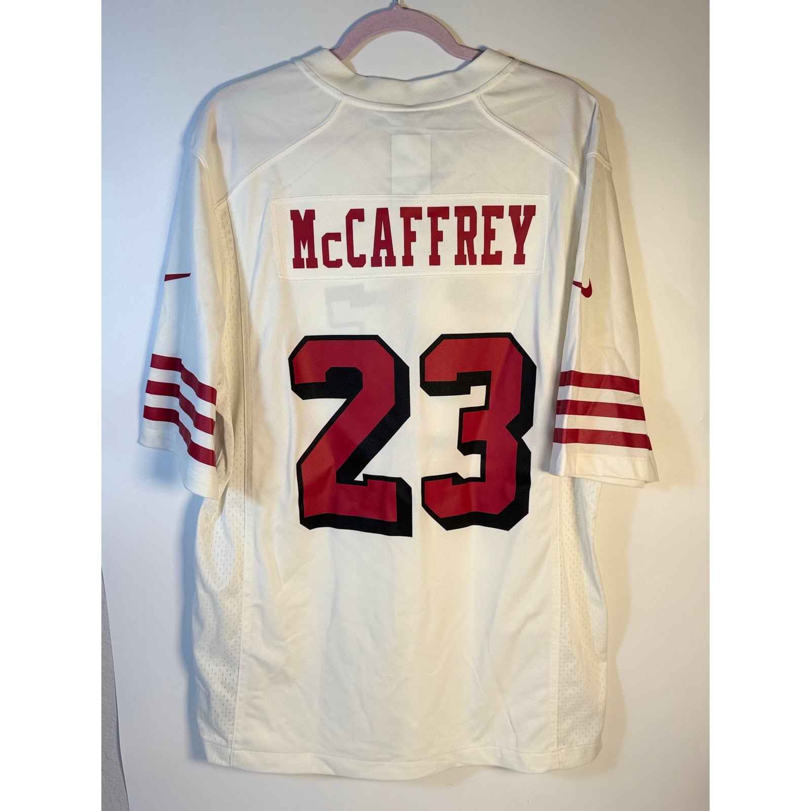 Nike Christian McCaffrey #23 San Francisco 49ers white NFL men's jersey, front view with team logo and player number.