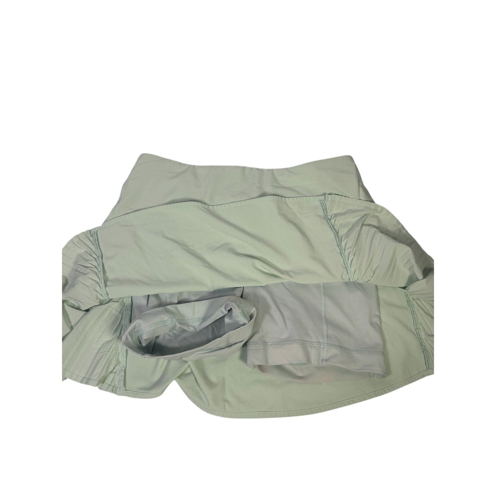Lululemon women's light mint pleated tennis skort with built-in shorts, size 6, showing front view and athletic design.
