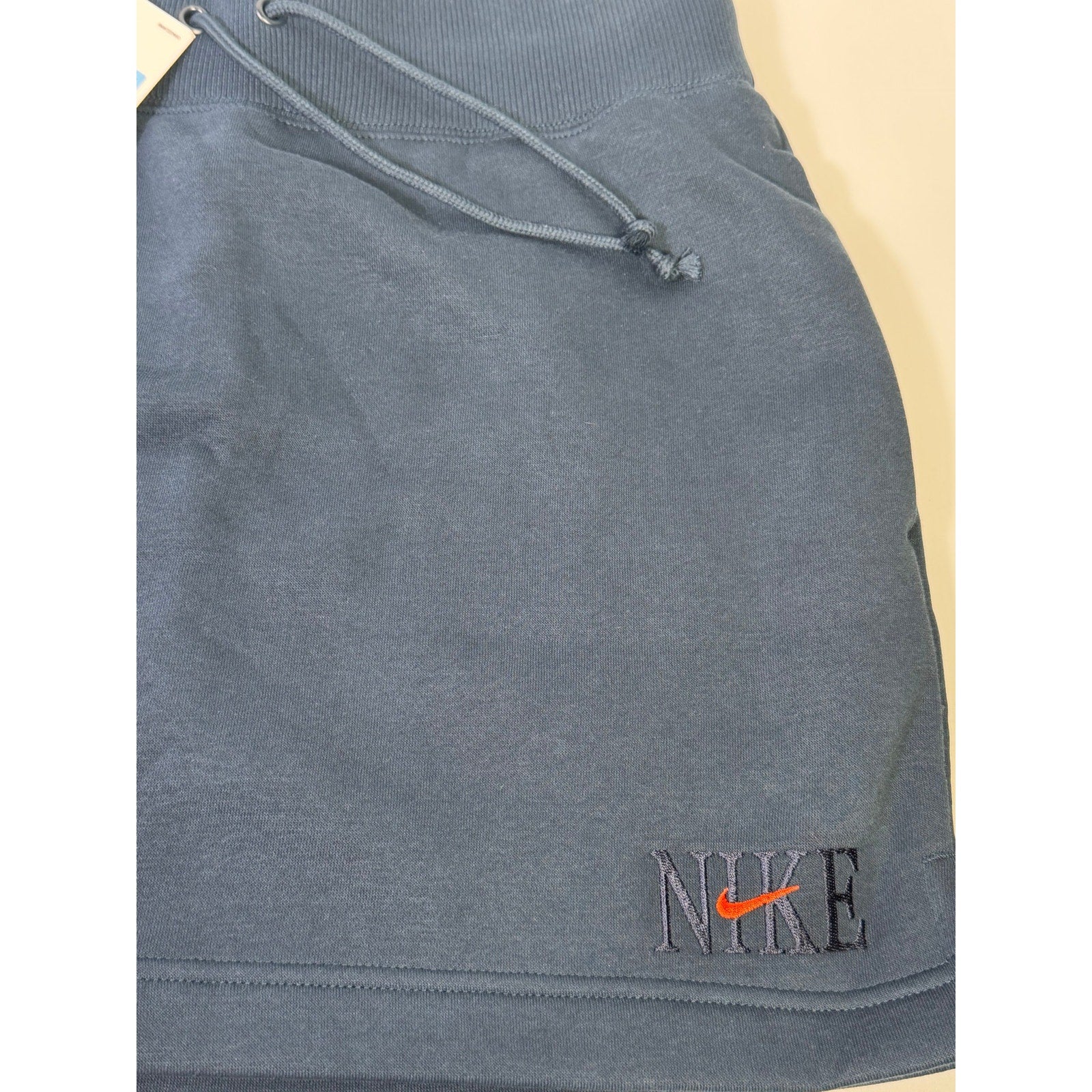 Nike women's navy blue fleece drawstring mini skirt, size M, new with tags, casual athletic style.