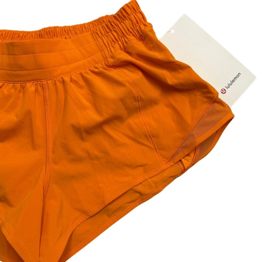 Lululemon Athletica Hotty Hot low-rise 2.5-inch lined women's shorts in black, displayed on a hanger.