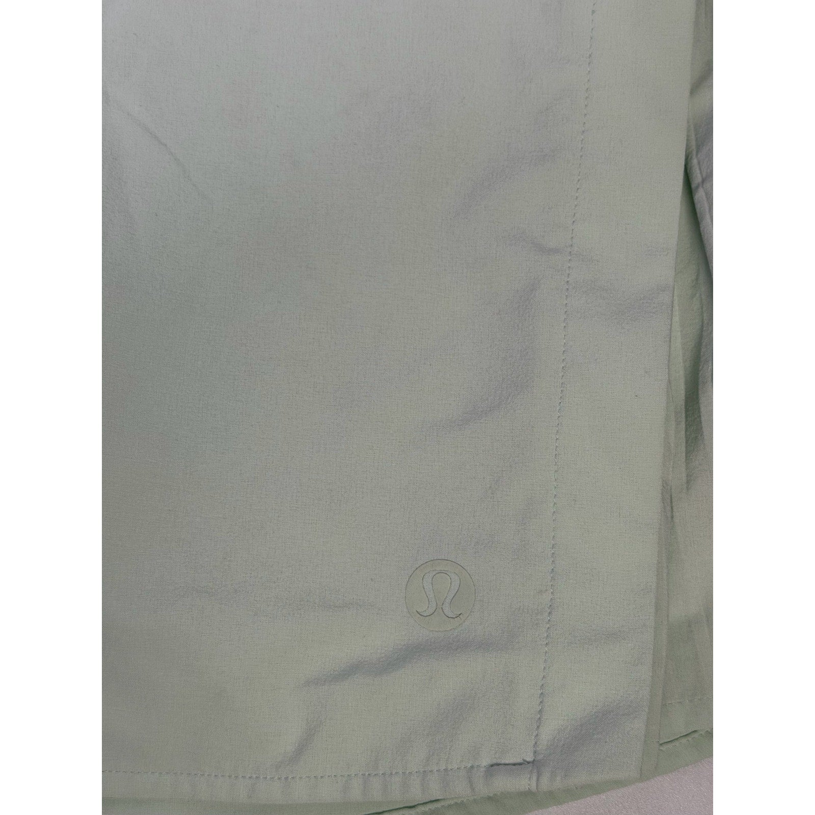 Lululemon women’s light mint pleated tennis skort with built-in shorts, size 6, showing the skirt's pleats and fabric details.