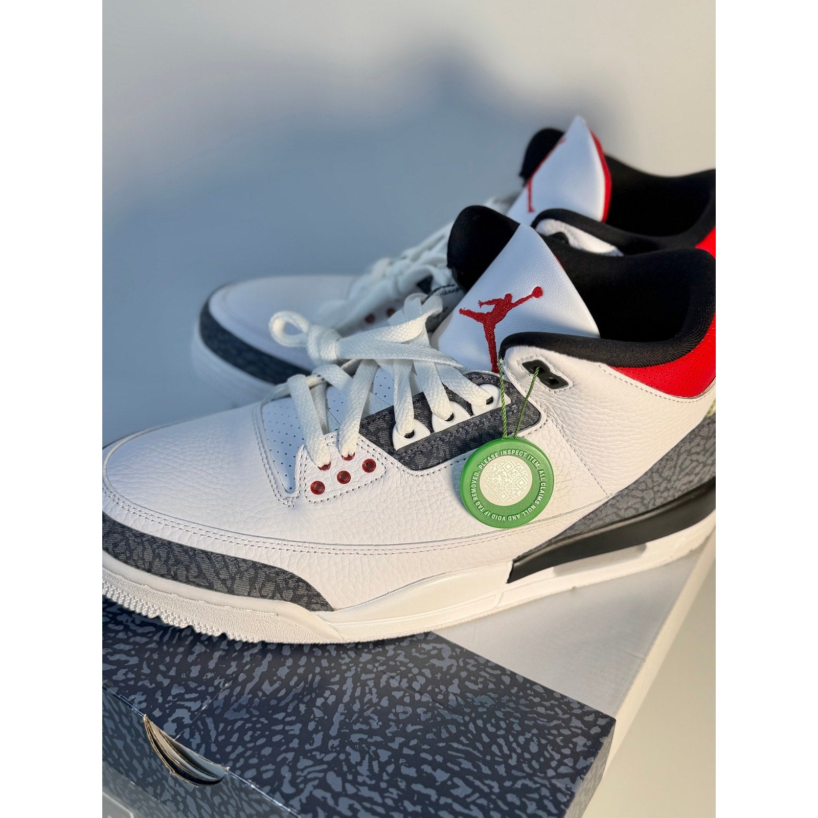 White Air Jordan 3 Retro sneakers with cement accents, men's athletic shoes, featuring classic Jordan design and branding.