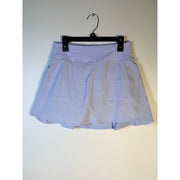 Lululemon women's light blue tennis skort, size 2, athletic activewear skirt with built-in shorts and sports waistband.