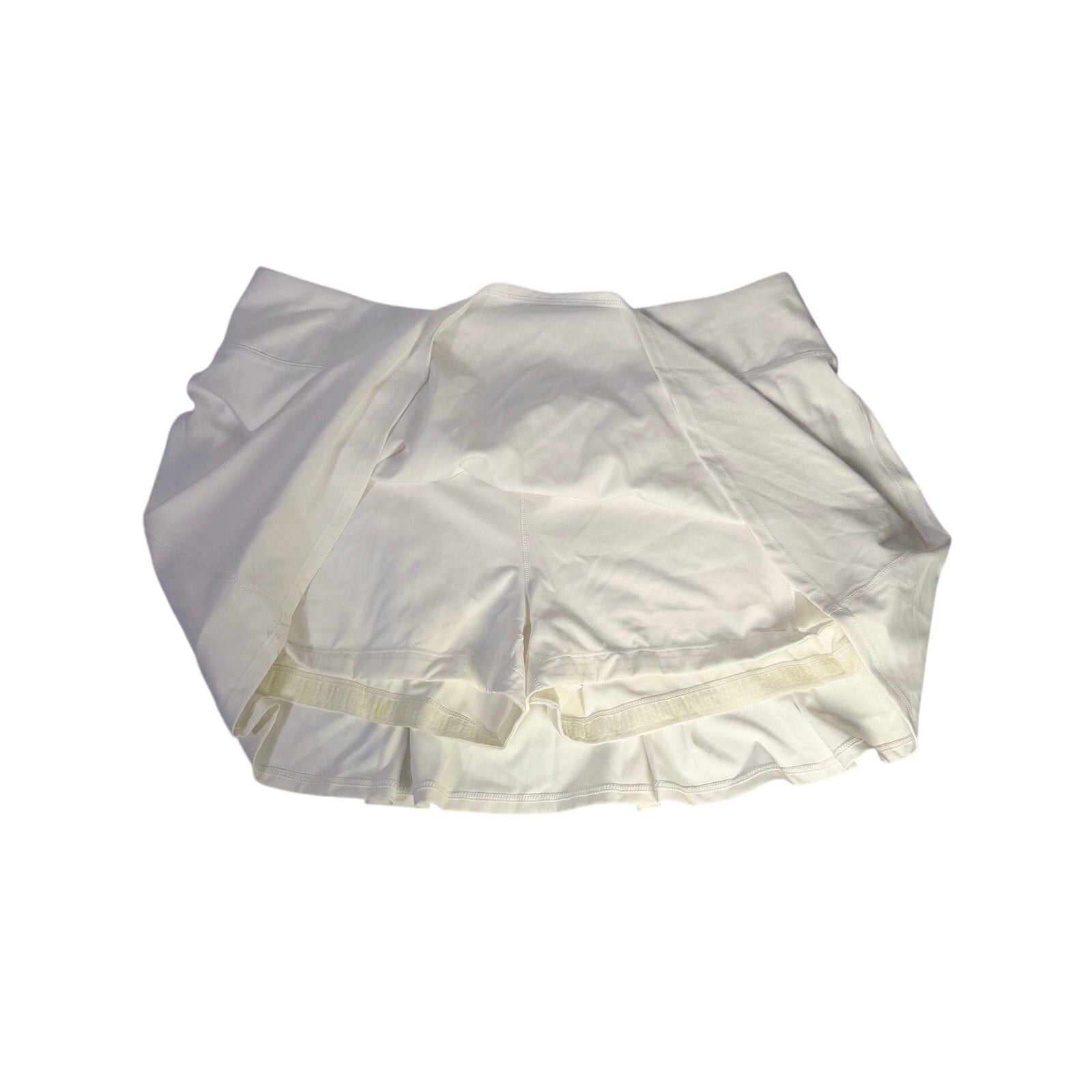 White CALIA Women's Court Collection high-rise skort with 14-inch length, shown in size XL, featuring a sleek athletic design.