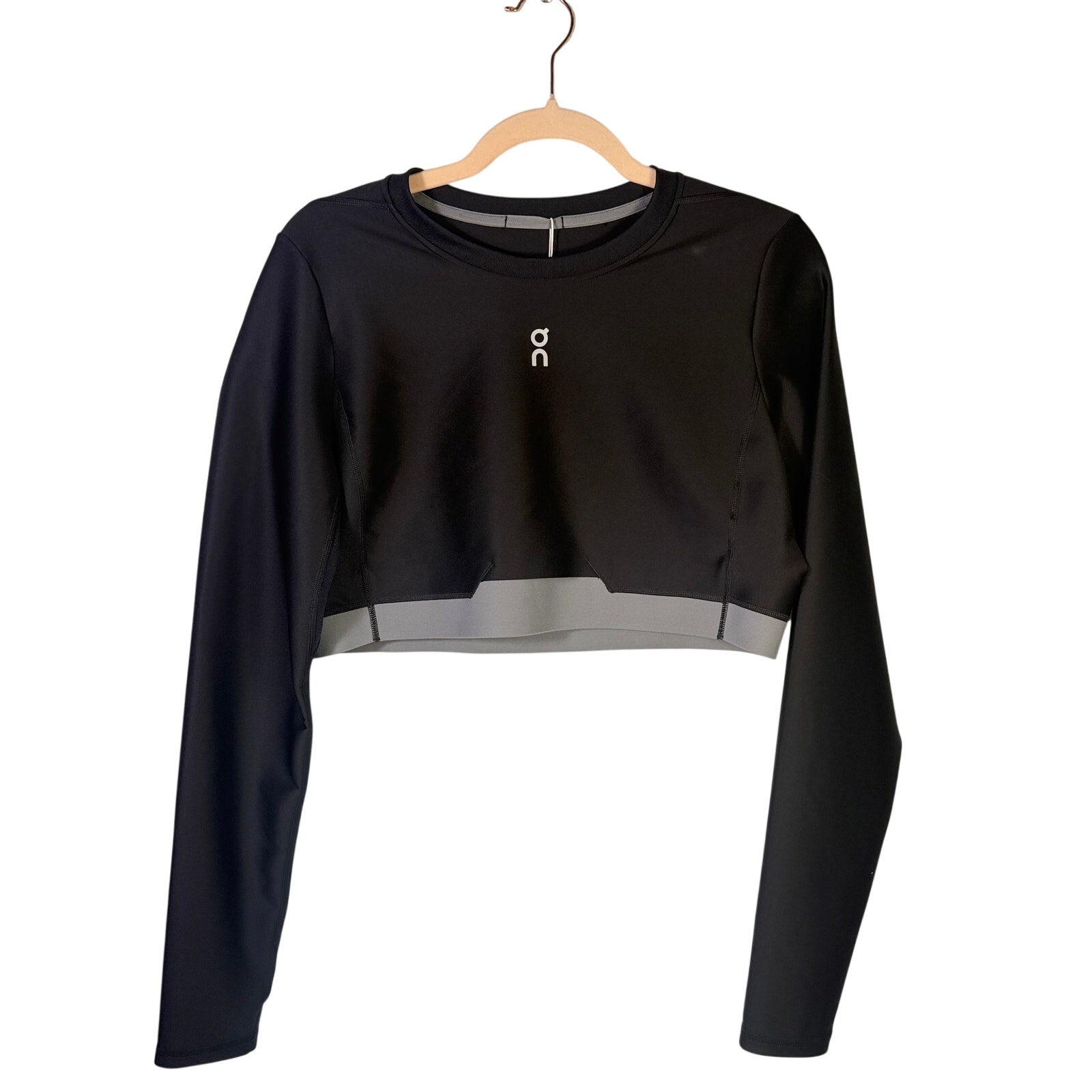 On women's black Train long-sleeve crop athletic top, size XL, made for active wear, shown on a hanger.