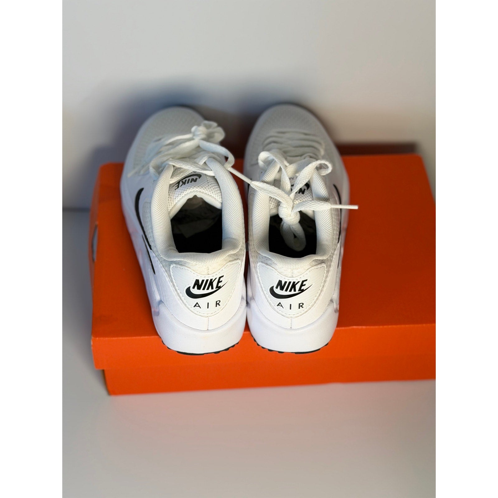 Nike Air Max 90 G women's golf shoes in white and black, shown in new condition with visible Nike logo and sporty design.