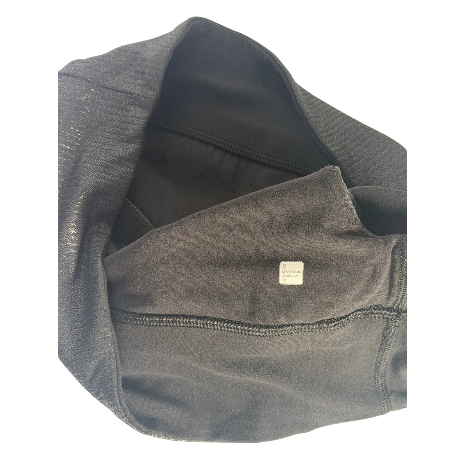 Lululemon women's one-shoulder foil sports bra in black, size 8, featuring sleek design and supportive fit.