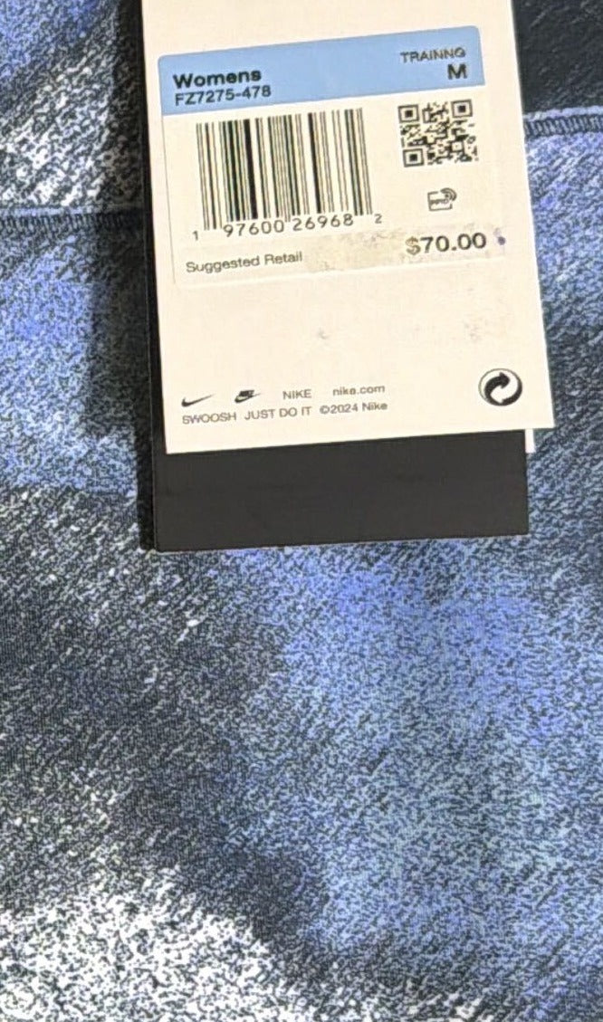 Nike women's navy blue high-waisted 7/8 printed leggings, size M, featuring a stylish pattern and comfortable fit.