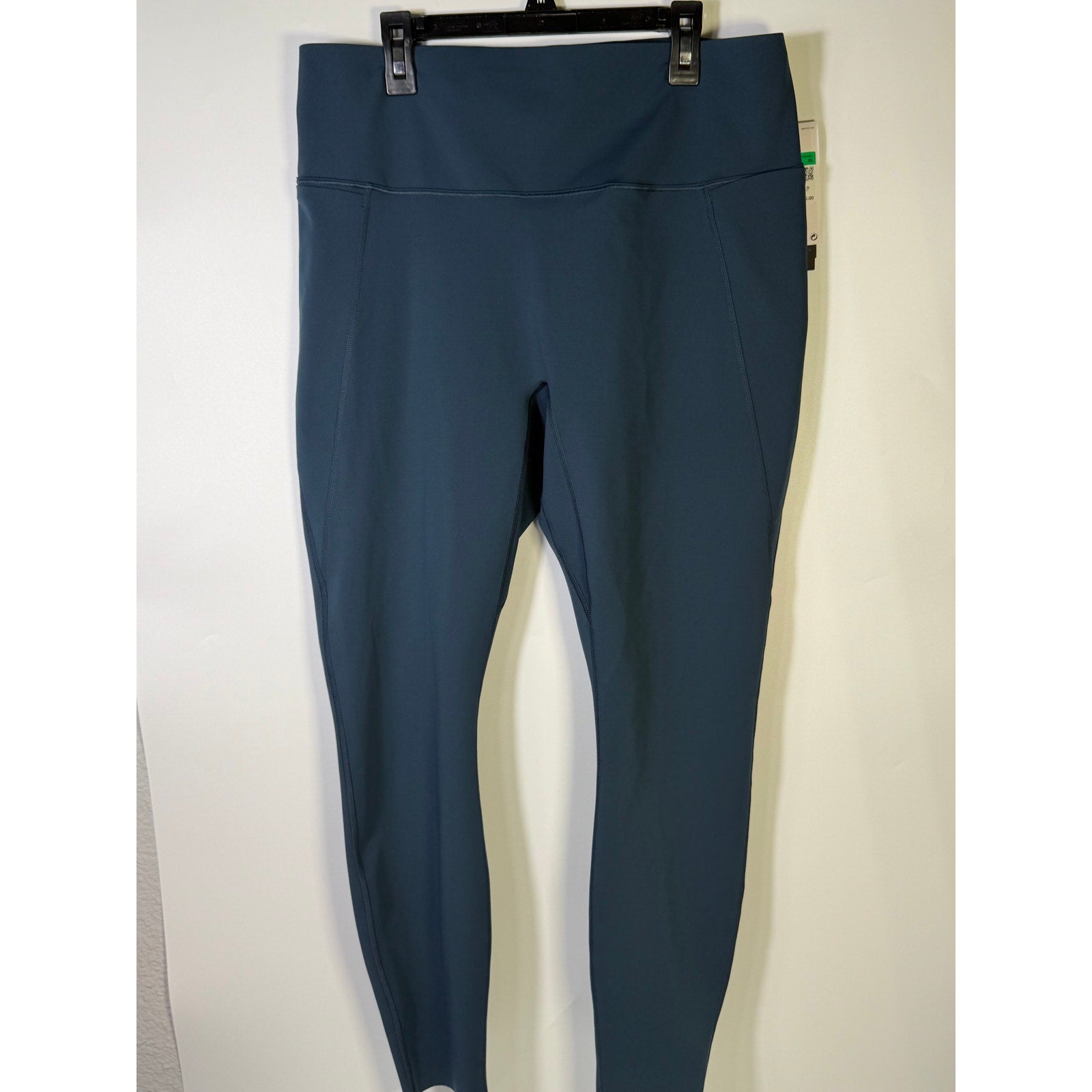 Nike women's high-waisted blue training leggings, XL size, fitted athletic leggings with Nike logo and stretch fabric for comfort.