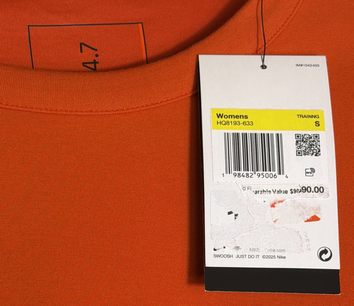 Nike 24.7 women's oversized orange cropped crew sweatshirt, size small, with Nike logo and relaxed fit visible.
