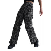 Nike Sportswear women's floral wide-leg track pants in black and gray, featuring a relaxed fit and floral pattern.