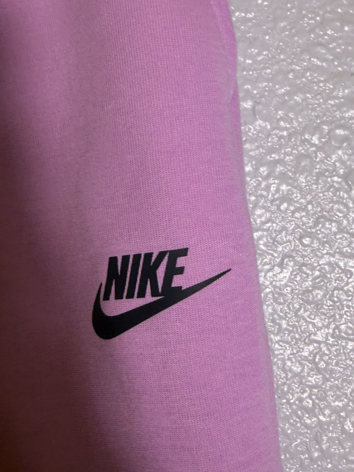 Pink Nike Sportswear Tech Fleece Joggers for women, size XS, mid-rise, soft fleece fabric, casual athletic pants.