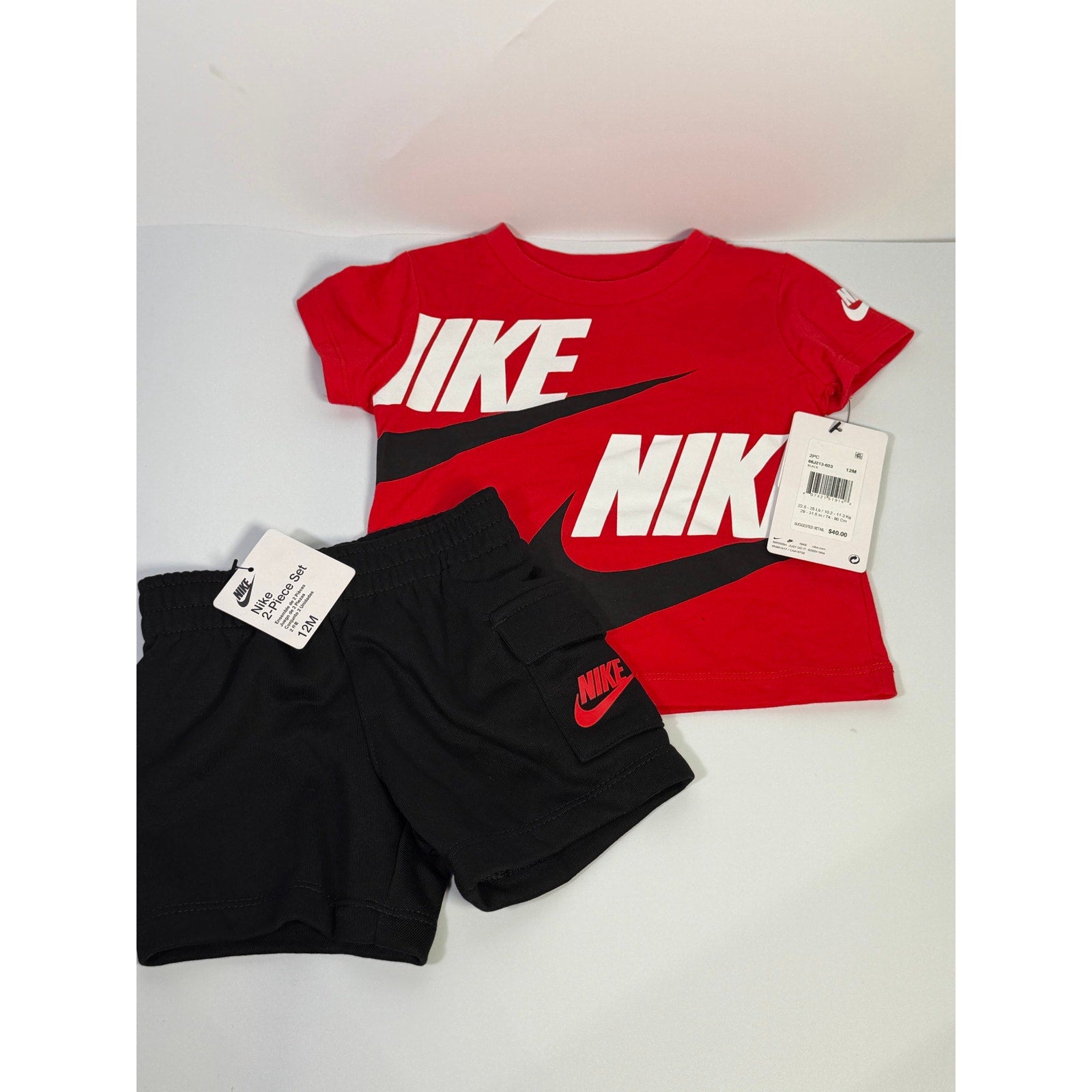 Nike baby boys 2-piece t-shirt and shorts set in red and black, size 12 months, with Nike branding visible on the clothing.