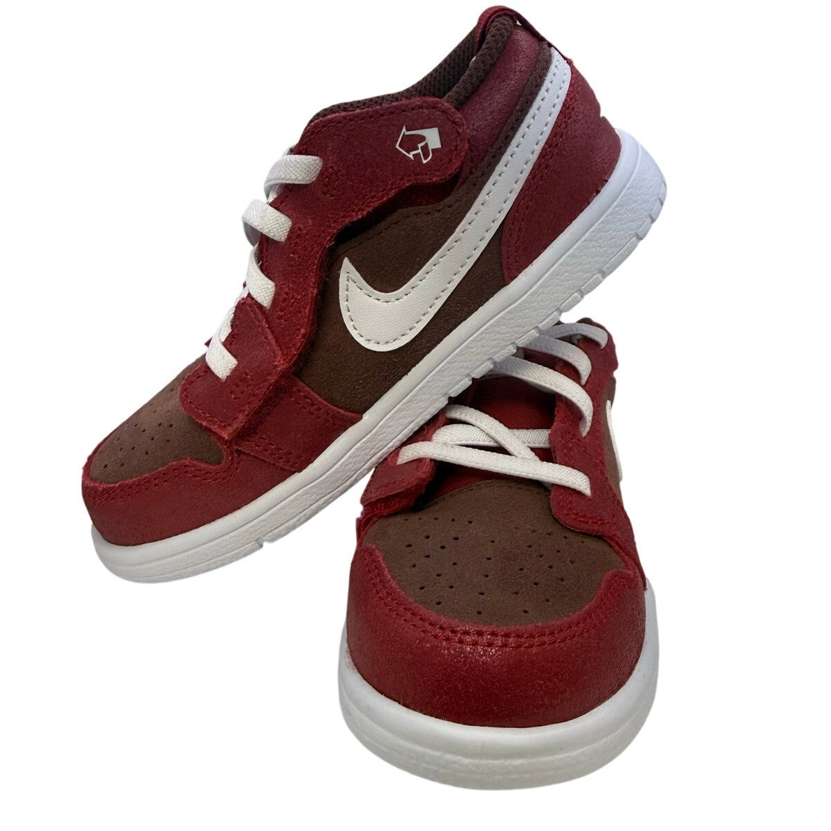Kids Nike Air Jordan 1 Low Alt SE PS sneakers in dark pony and varsity red with white accents, featuring Nike branding and low-top design.