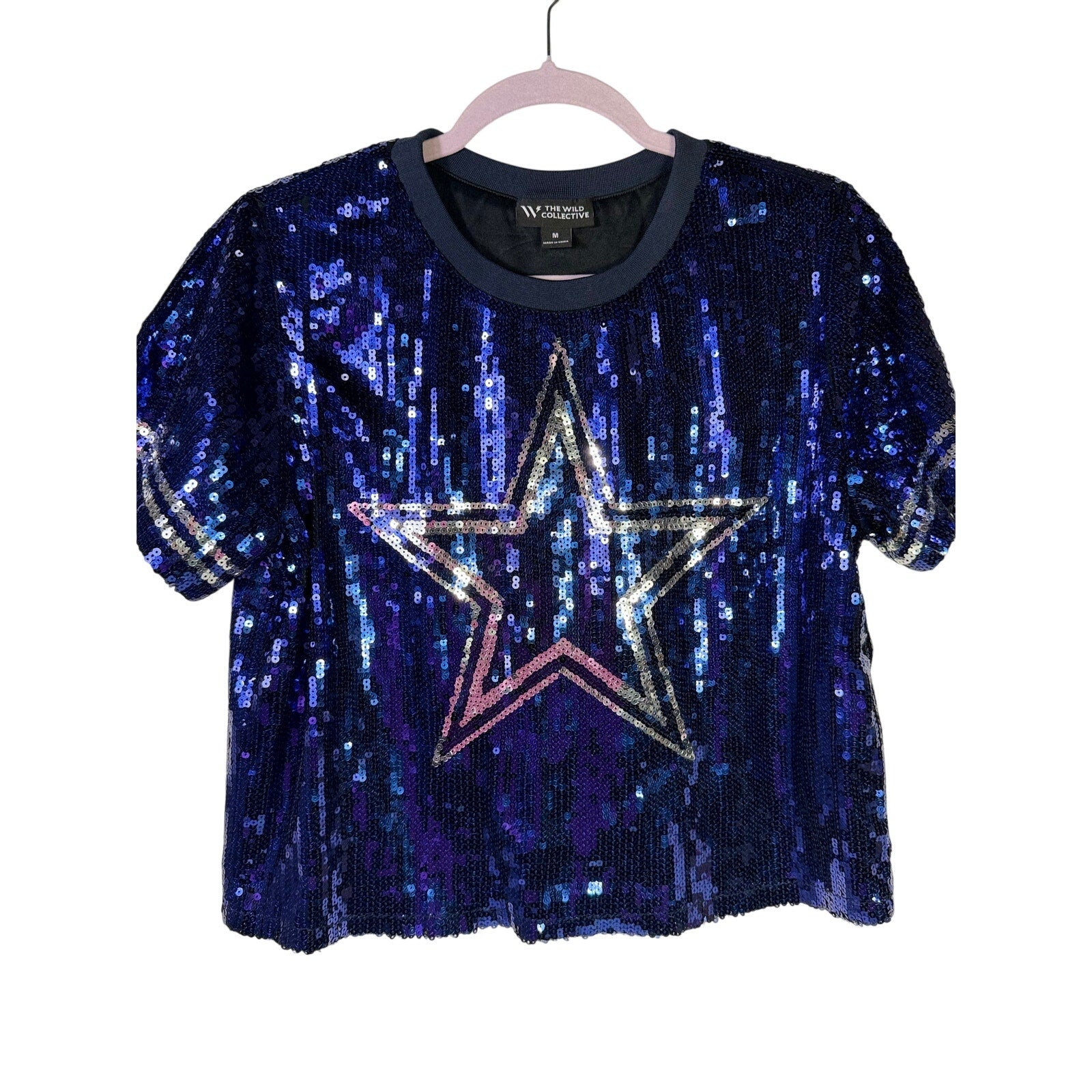 Women's navy blue T-shirt by The Wild Collective featuring a sequin Dallas Cowboys star design. Medium size, casual style.