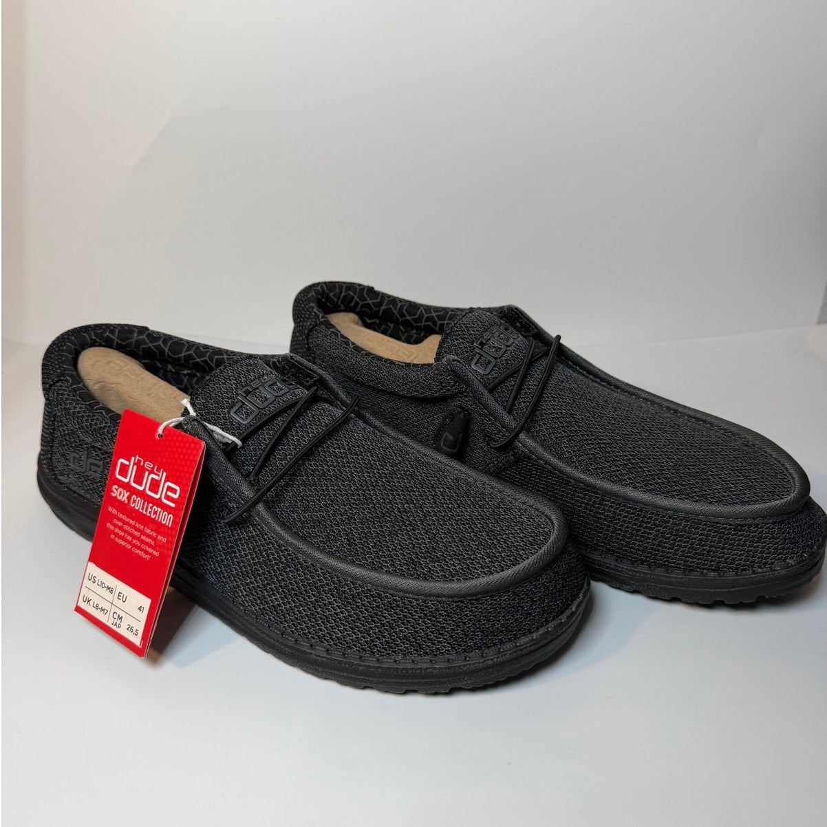 Hey Dude Wally Sox Micro men's slip-on shoes in total black, showing the comfortable slip-on design and soft fabric upper.