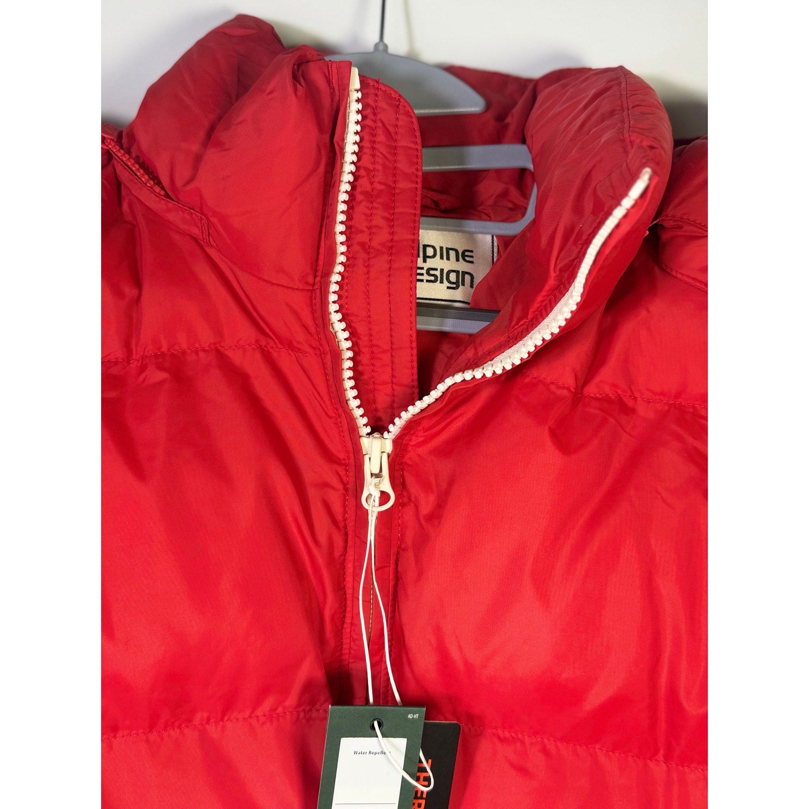 Red Alpine Design men's HyperDRY puffer jacket, size small, hooded and insulated, displayed on a hanger.
