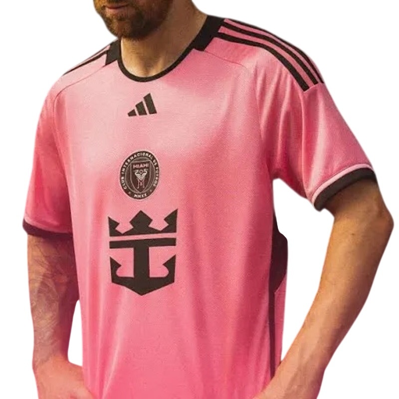 Pink Adidas Inter Miami CF Lionel Messi jersey, featuring team logo and Messi's name and number, displayed on a flat surface.