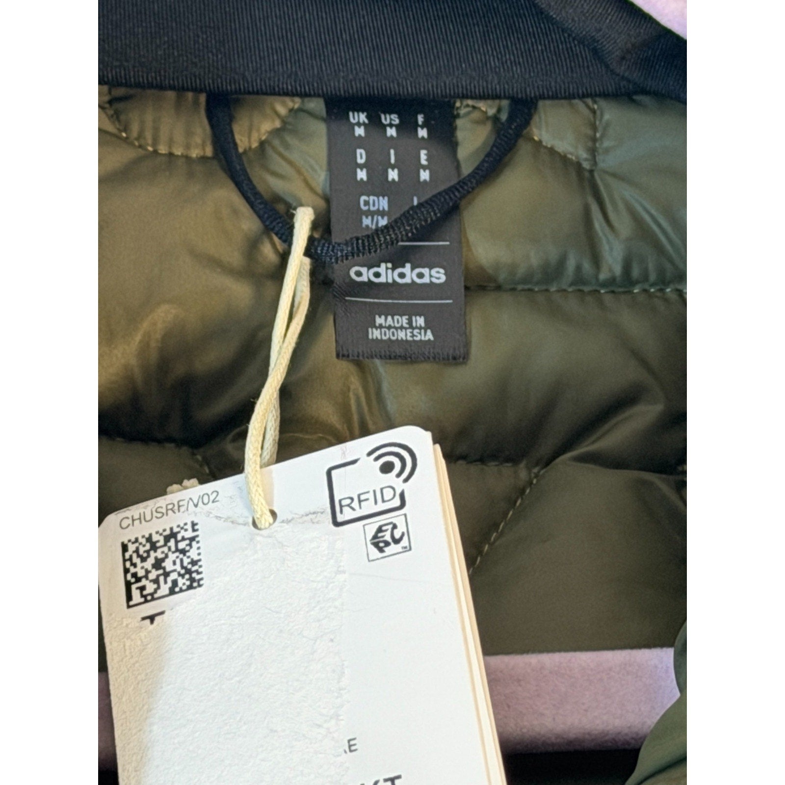 Men's Adidas Terrex insulated puffer jacket in olive green, featuring a padded design, front zipper, and brand logo.